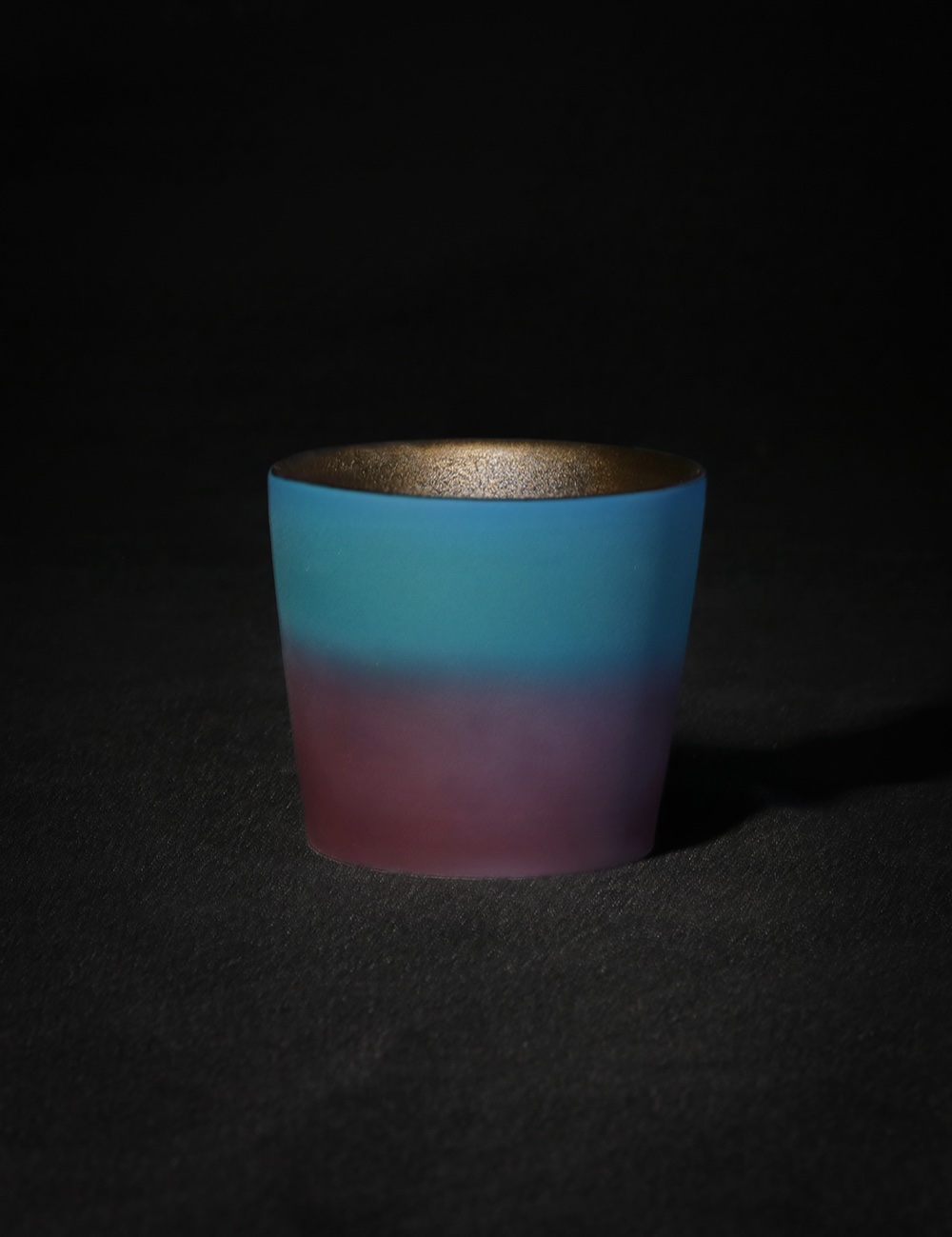 Ceramic cup with blue to pink gradient glaze