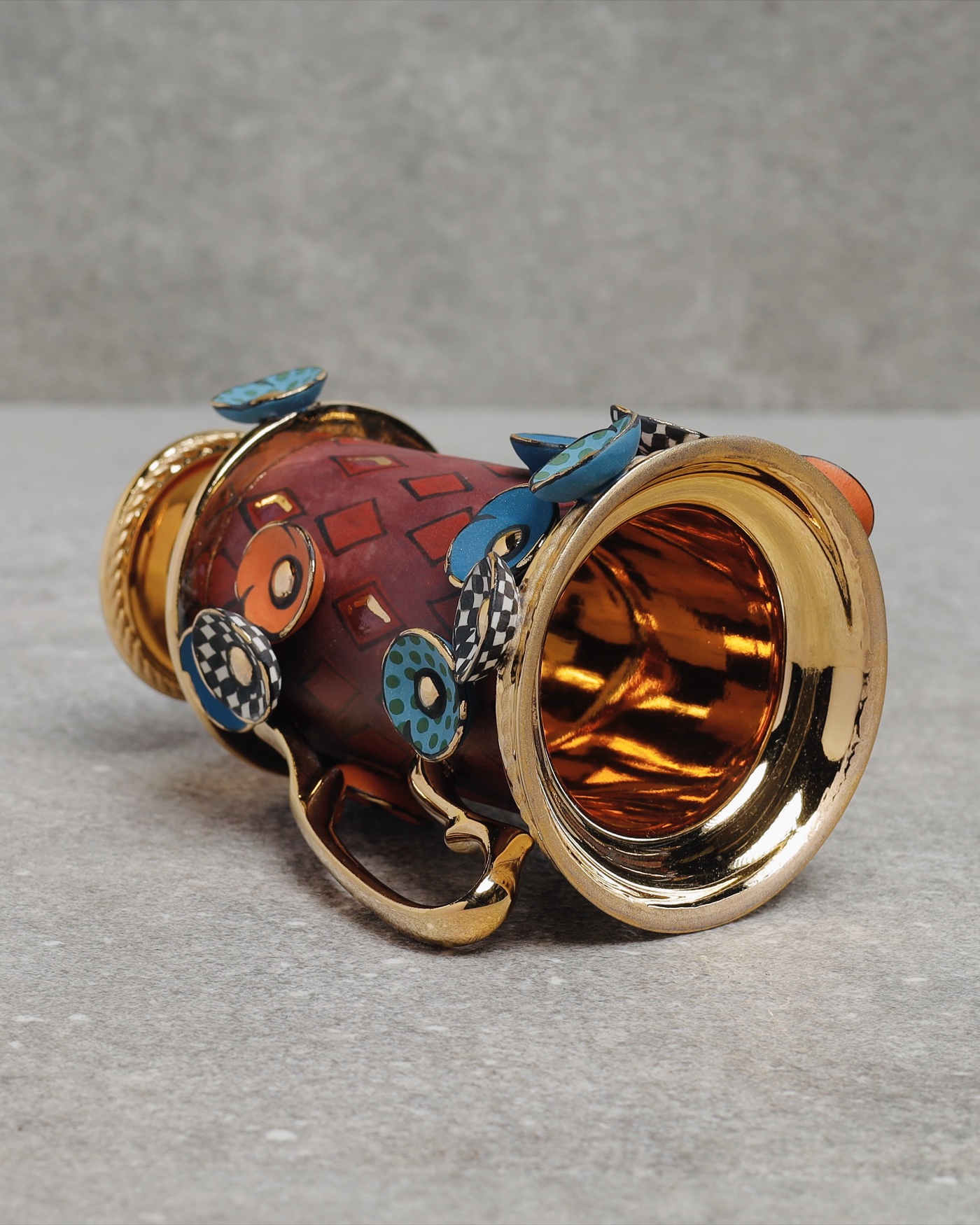 Elaborate gold-trimmed cup with jewel cabochon